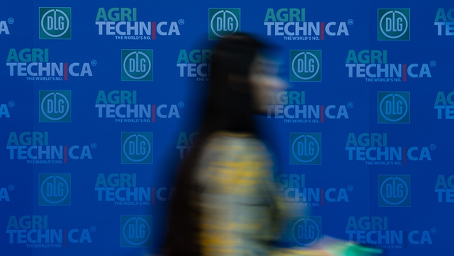 Weichgezeichnete Frau vor blauen Hintergrund der AGRITECHNICA